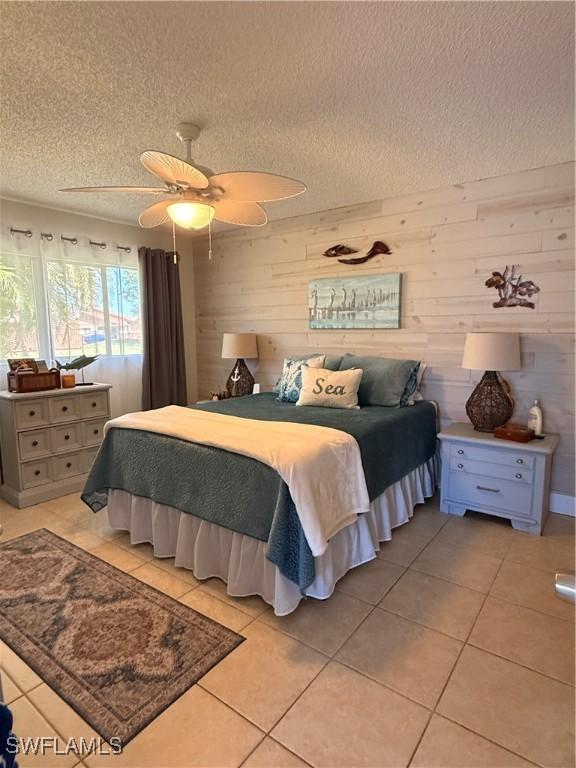 6411 Royal Woods Dr, Fort Myers, FL 33908 - bedroom with light tile patterned flooring, a ceiling fan, and a textured ceiling
