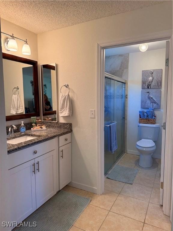 6411 Royal Woods Dr, Fort Myers, FL 33908 - full bath featuring tile patterned flooring, toilet, vanity, a stall shower, and a textured ceiling
