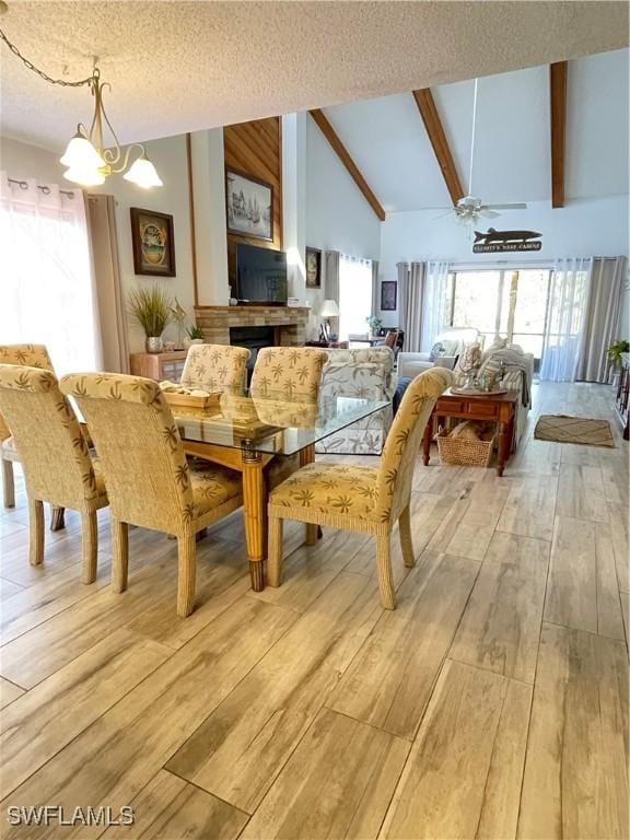 6411 Royal Woods Dr, Fort Myers, FL 33908 - dining area featuring a ceiling fan, high vaulted ceiling, light wood-style flooring, a textured ceiling, and beamed ceiling