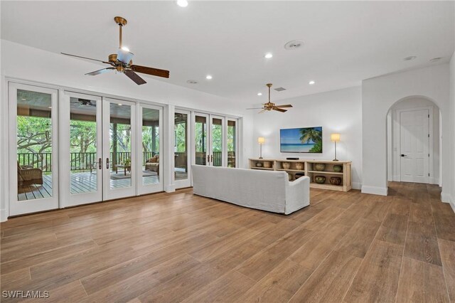 20732 Charing Cross Cir, Estero, FL 33928 - living room with a ceiling fan, recessed lighting, light wood-type flooring, baseboards, and arched walkways