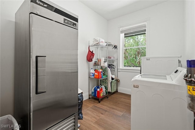 20732 Charing Cross Cir, Estero, FL 33928 - washroom with washer and dryer, wood finished floors, and baseboards