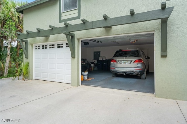 20732 Charing Cross Cir, Estero, FL 33928 - garage featuring concrete driveway, a garage door opener, and electric panel