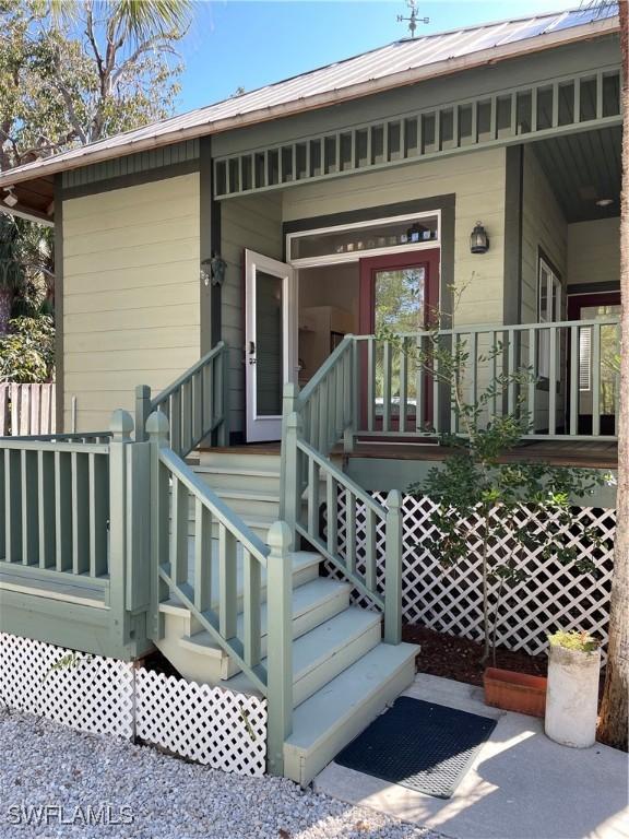 20732 Charing Cross Cir, Estero, FL 33928 - property entrance with a porch