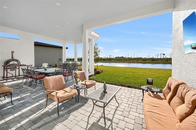 view of patio / terrace featuring a water view and outdoor dining space