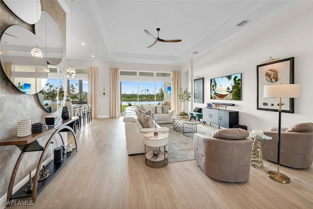 15445 Turin Dr, Naples, FL 34114 - living area with a raised ceiling, wood finished floors, a ceiling fan, and baseboards