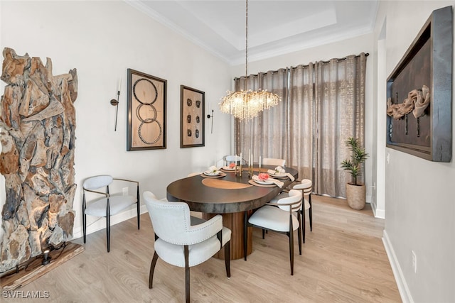 15445 Turin Dr, Naples, FL 34114 - dining area featuring light wood-style floors, a chandelier, baseboards, ornamental molding, and a raised ceiling