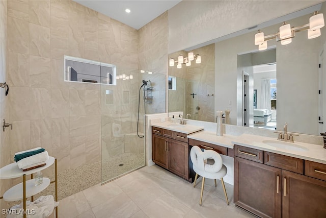 full bath with a walk in shower and double vanity