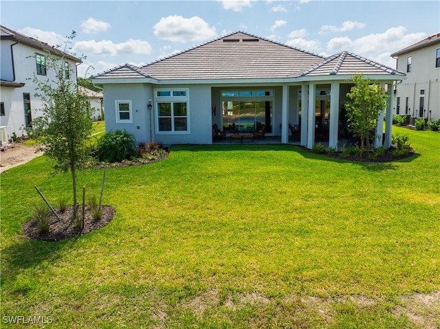 15445 Turin Dr, Naples, FL 34114 - back of house with a yard, stucco siding, and a tiled roof