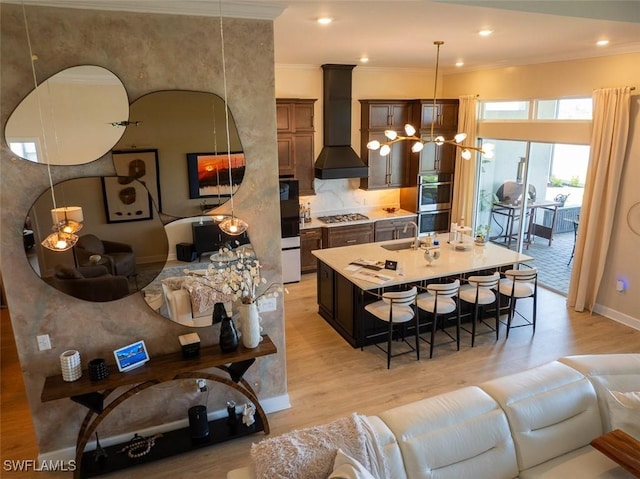 15445 Turin Dr, Naples, FL 34114 - living room featuring light wood-style flooring, a chandelier, ornamental molding, recessed lighting, and baseboards