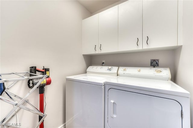 8201 Grand Palm Dr Unit 4, Estero, FL 33967 - washroom featuring cabinet space, washer and dryer, and baseboards