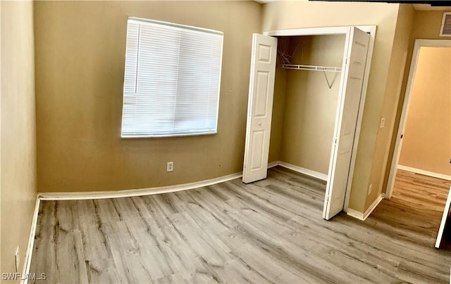 4844 Golfview Blvd, Lehigh Acres, FL 33973 - unfurnished bedroom featuring visible vents, baseboards, a closet, and wood finished floors