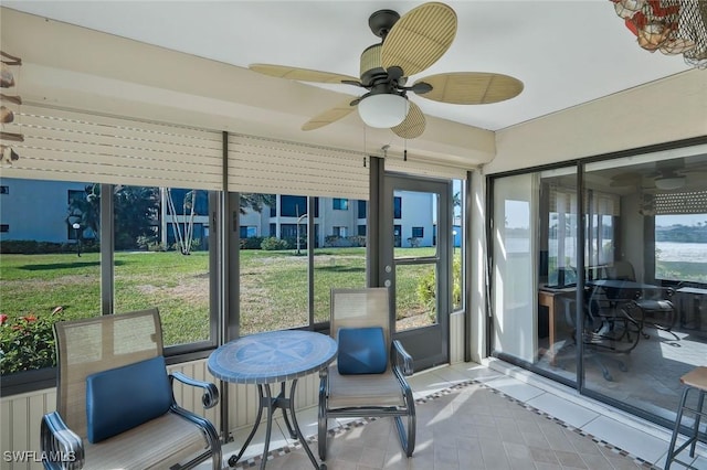 sunroom / solarium with a ceiling fan