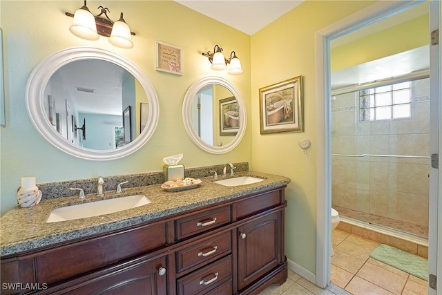 full bathroom featuring a stall shower, tile patterned flooring, and a sink