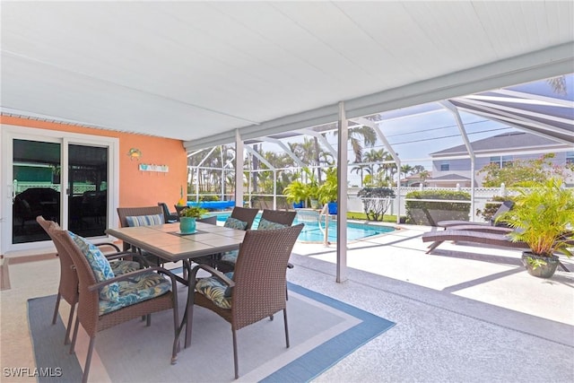 view of patio / terrace with a fenced in pool, a lanai, and outdoor dining space