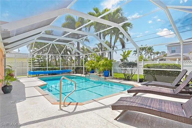 view of swimming pool with a patio, fence, a fenced in pool, and glass enclosure