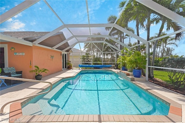 pool featuring a lanai and a patio