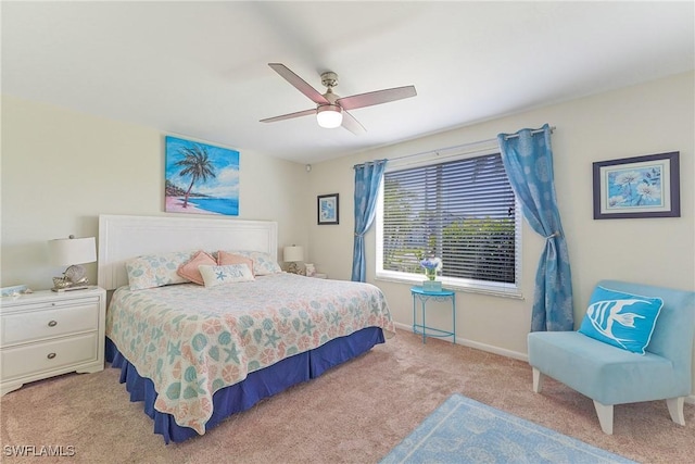 bedroom with light colored carpet, ceiling fan, and baseboards