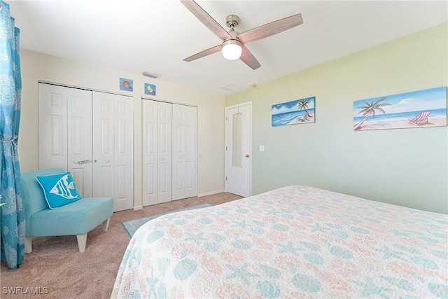 bedroom featuring two closets, carpet floors, ceiling fan, and visible vents