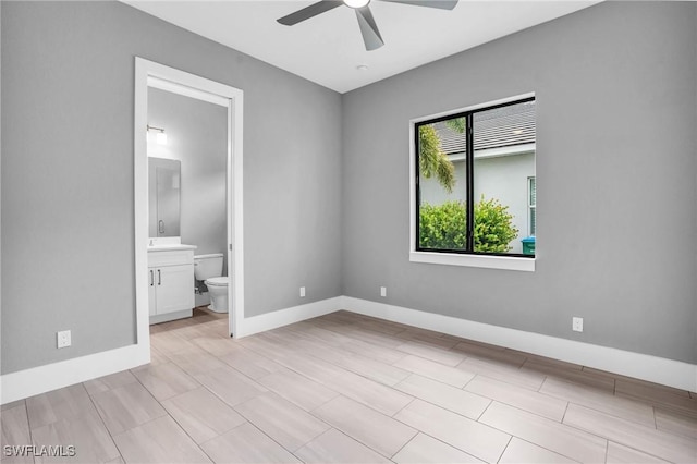 1236 NW 37th Pl, Cape Coral, FL 33993 - unfurnished bedroom with connected bathroom, a ceiling fan, and baseboards