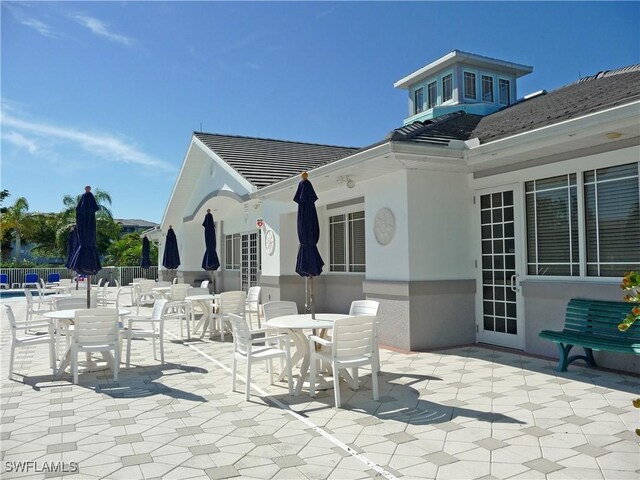 16605 Lake Circle Dr Unit 337, Fort Myers, FL 33908 - view of patio / terrace with outdoor dining area and fence