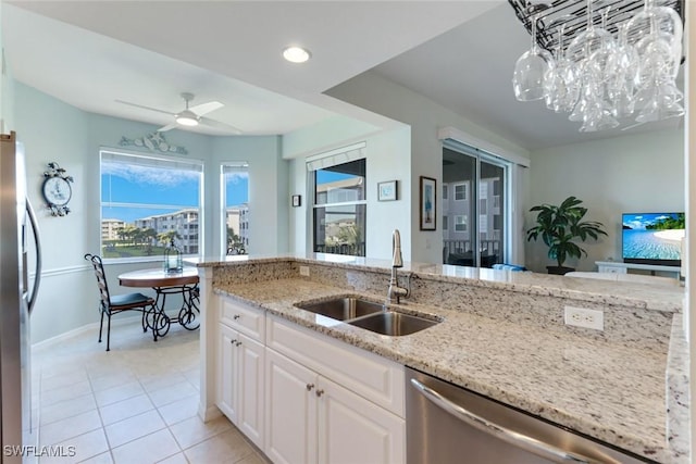 16605 Lake Circle Dr Unit 337, Fort Myers, FL 33908 - kitchen featuring ceiling fan with notable chandelier, a sink, white cabinetry, stainless steel appliances, and light stone countertops