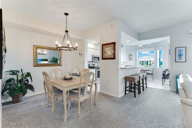 16605 Lake Circle Dr Unit 337, Fort Myers, FL 33908 - dining area with light colored carpet, baseboards, and an inviting chandelier