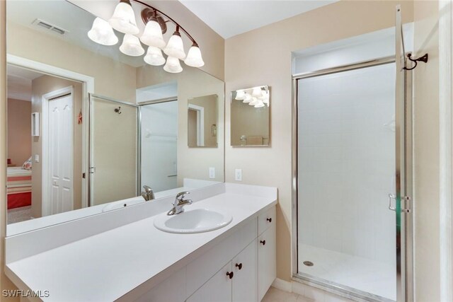 16605 Lake Circle Dr Unit 337, Fort Myers, FL 33908 - ensuite bathroom featuring an inviting chandelier, a shower stall, vanity, and visible vents