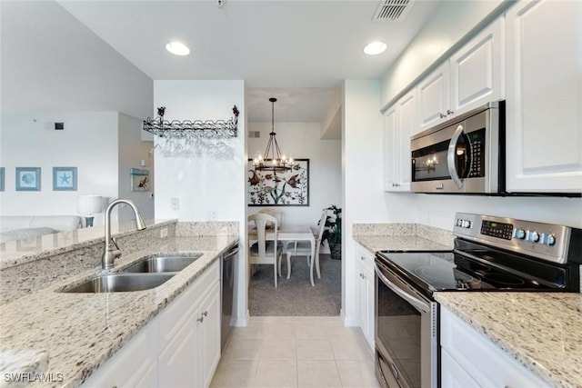 16605 Lake Circle Dr Unit 337, Fort Myers, FL 33908 - kitchen with light stone countertops, visible vents, appliances with stainless steel finishes, and a sink