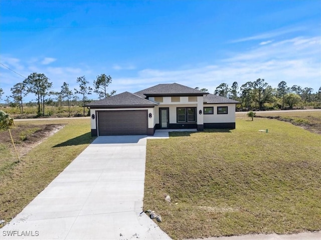 9020 S Casa Ct, Labelle, FL 33935 - prairie-style house with a front lawn, a garage, driveway, and stucco siding