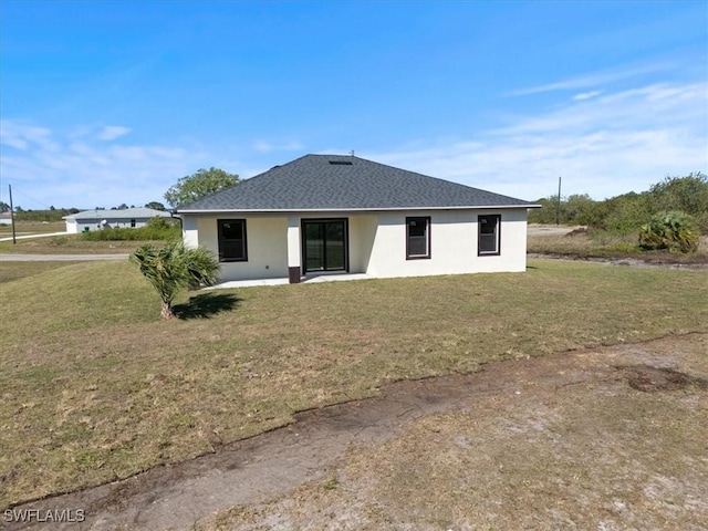 9020 S Casa Ct, Labelle, FL 33935 - rear view of property featuring a lawn, roof with shingles, and stucco siding