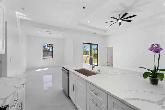 9020 S Casa Ct, Labelle, FL 33935 - kitchen with ceiling fan, light stone countertops, white cabinetry, a raised ceiling, and a sink