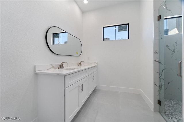 9020 S Casa Ct, Labelle, FL 33935 - bathroom with double vanity, baseboards, a marble finish shower, and a sink