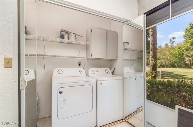 laundry room with cabinet space and washing machine and dryer