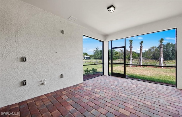 unfurnished sunroom with visible vents
