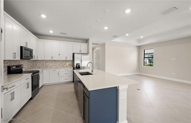 kitchen featuring decorative backsplash, visible vents, a sink, black appliances, and light tile patterned flooring