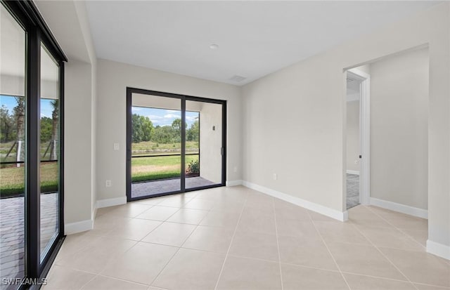 empty room featuring light tile patterned floors and baseboards