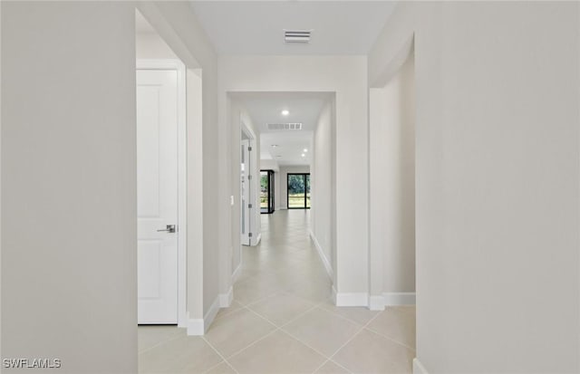corridor with visible vents, recessed lighting, baseboards, and light tile patterned floors