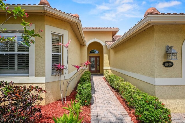 13800 Farnese Dr, Estero, FL 33928 - property entrance with a tile roof and stucco siding