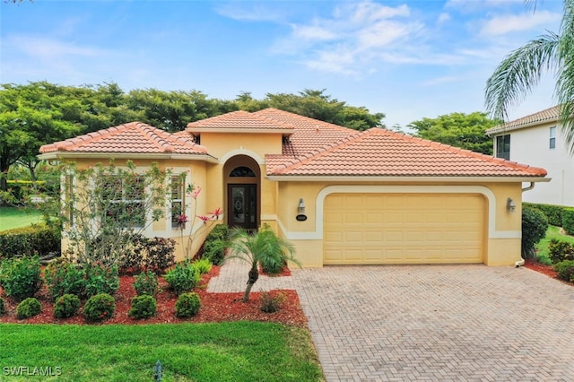 13800 Farnese Dr, Estero, FL 33928 - mediterranean / spanish-style home with a garage, stucco siding, decorative driveway, and a tile roof