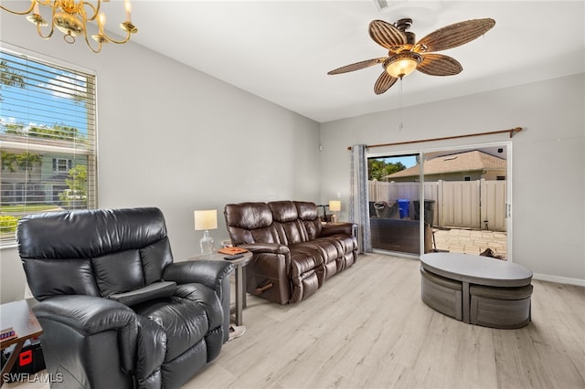 3627 Pine Oak Cir Unit 101, Fort Myers, FL 33916 - living area with a chandelier, light wood-style flooring, and a ceiling fan