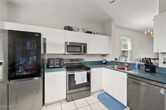 3627 Pine Oak Cir Unit 101, Fort Myers, FL 33916 - kitchen with stainless steel appliances, a chandelier, white cabinets, dark countertops, and light tile patterned floors
