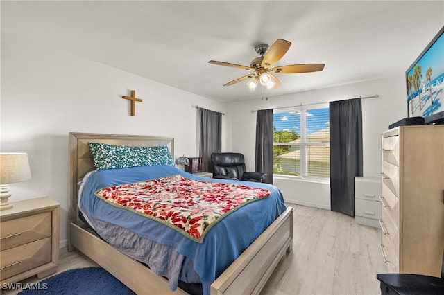 3627 Pine Oak Cir Unit 101, Fort Myers, FL 33916 - bedroom with light wood-style floors, a ceiling fan, and baseboards