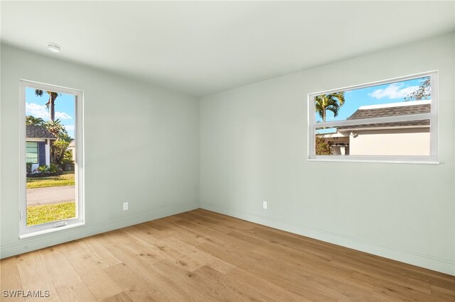 13 Knights Bridge Rd Unit A49, Naples, FL 34112 - empty room with wood finished floors and baseboards