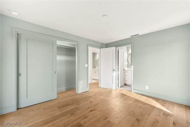 13 Knights Bridge Rd Unit A49, Naples, FL 34112 - unfurnished bedroom featuring light wood-style floors, baseboards, a closet, and ensuite bath