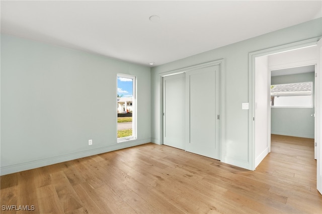 13 Knights Bridge Rd Unit A49, Naples, FL 34112 - unfurnished bedroom with light wood-style flooring, a closet, and baseboards