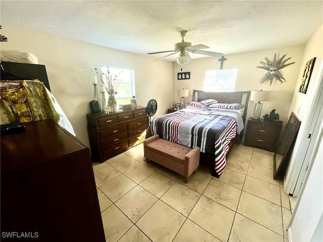 bedroom featuring light tile patterned floors and ceiling fan