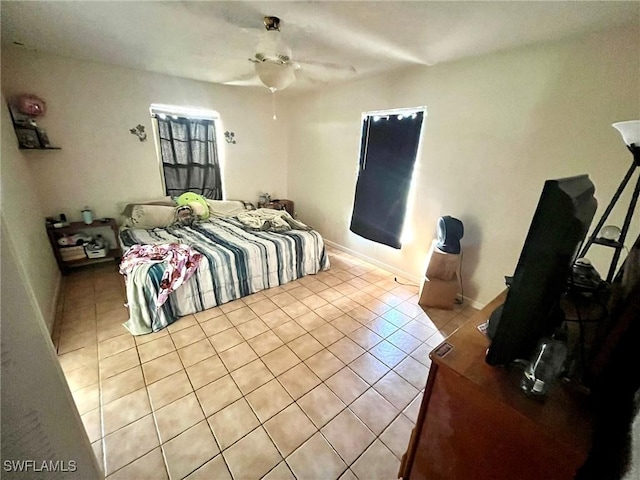 bedroom with tile patterned floors, baseboards, and ceiling fan