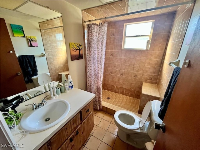 full bathroom featuring tile patterned floors, toilet, vanity, and a tile shower
