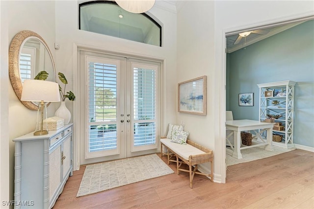 doorway to outside with wood finished floors, french doors, and ornamental molding