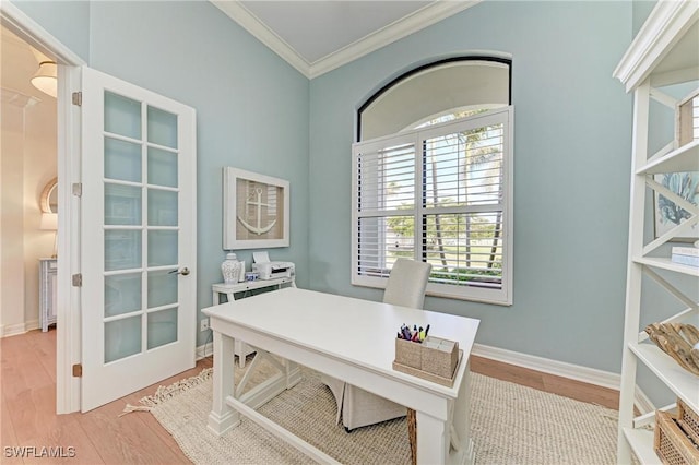 office with baseboards, wood finished floors, and crown molding